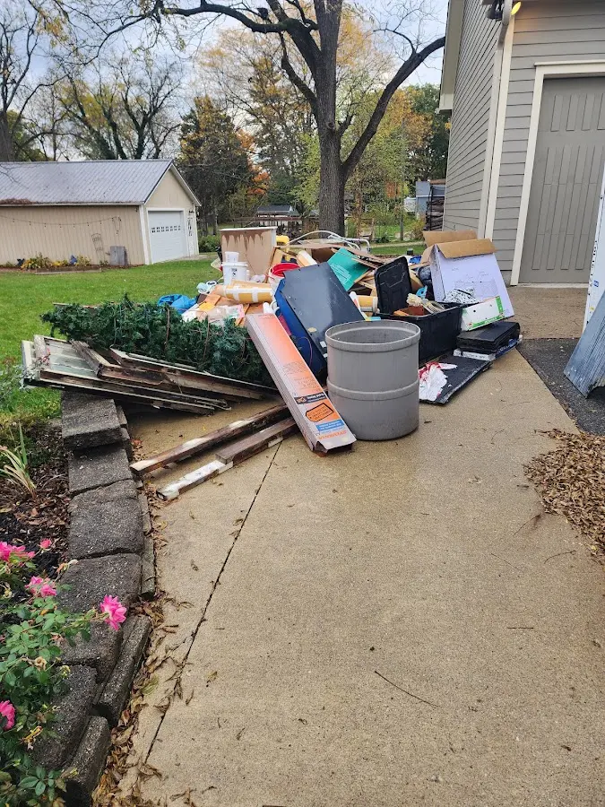 Dumpster being loaded with debris for Estate Cleanout Dumpster Rental in Shoreview